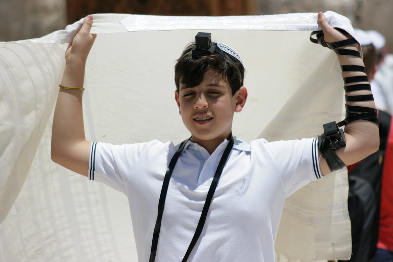 young Jewish boy dons a Tallit
